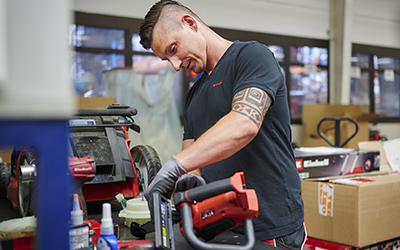 A man using an Einhell tool. 